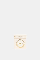 Trudon Cire Absolu packaging blanc ivoire abeilles dorées en couronne, branding 1643 relief