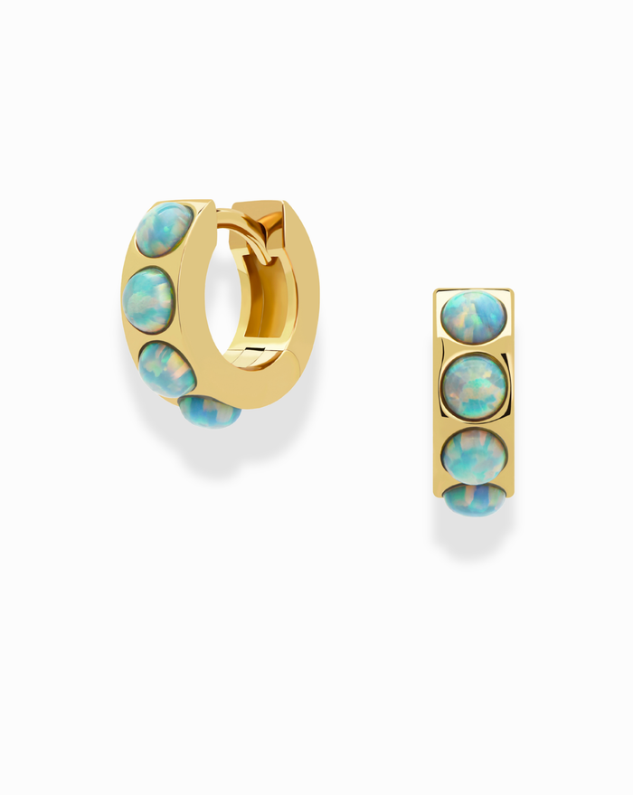 The Mod + Jo Brielle Opal Huggies are gold hoop earrings, each 10.5mm in size, featuring three vertically set oval opal stones. Displayed on a white background, one earring shows the side view and the other the front.