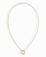 The Callum Tennis Charm Clip Necklace by Mod + Jo features a dainty gold-plated chain with a small circular pendant, elegantly displayed on a white background.