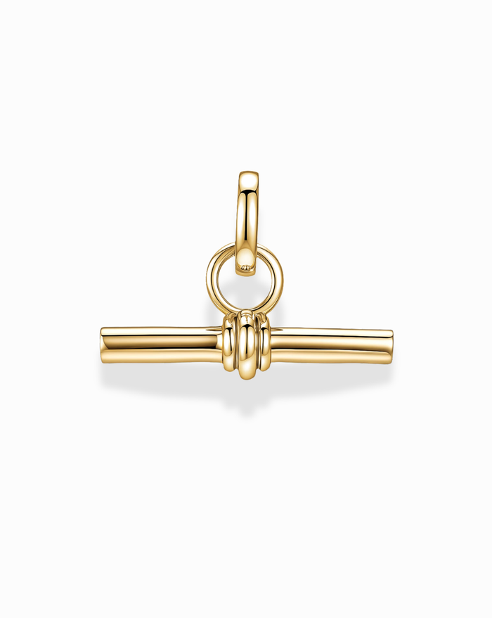 The Elliot Toggle Charm by Mod + Jo features a horizontal 14k gold bar suspended by three rings at the center, connected to a circular bail—all showcased against a white background for an elegant, architectural effect.