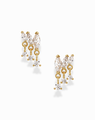 Introducing the Gabby Marquise Dangle Studs by Mod + Jo—gold-plated earrings featuring clear teardrop, marquise, and round cubic zirconia gemstones. Each earring showcases two prominent stones at the top and three sparkling gems dangling below, elegantly designed to catch the light against a plain white background.