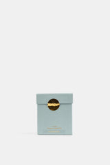 Trudon La Figuerie packaging luxe bleu céladon fermé par sceau métallique doré, présentation minimaliste