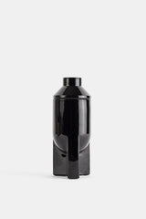 Bougie L'apparition 200g flacon noir laqué brillant design sculptural minimaliste sur socle géométrique SS26
