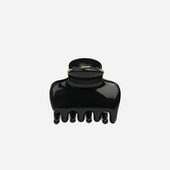 The BRAID & BOW Medium Black Swirl Hair Claw, made from black plastic with five prongs, is featured against a plain white background. This chic hair accessory provides a strong, secure hold for everyday styling.