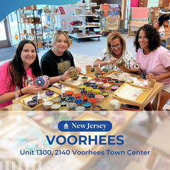 Four women crafting mosaic art projects with colorful beads at Voorhees Town Center in New Jersey