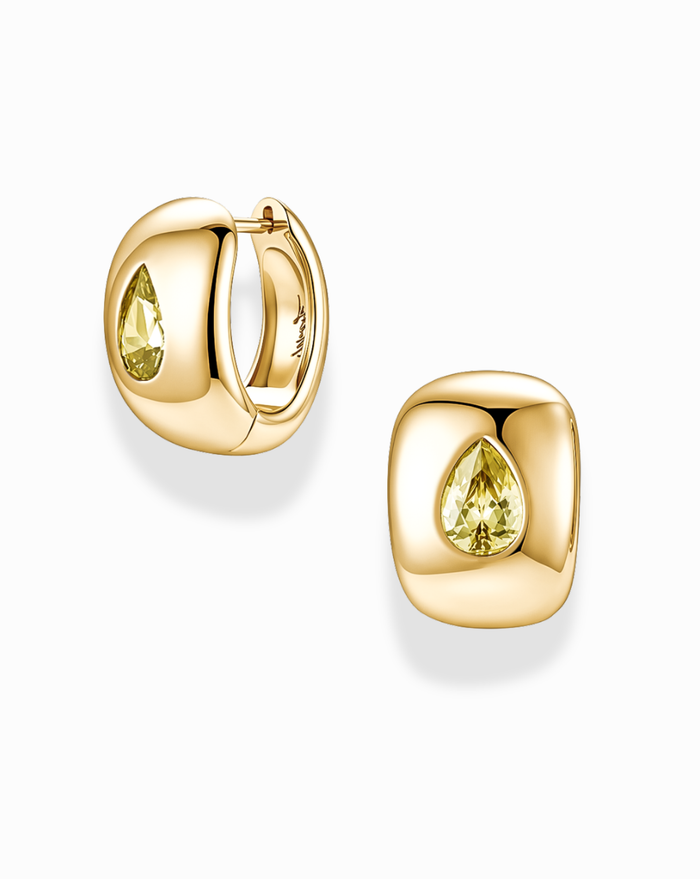 Introducing the Penn Gemstone Hoops by Mod + Jo: These gold-plated brass earrings feature a unique, rounded cushion shape with a striking pear-shaped yellow gemstone at the center. Completely nickel and lead-free, they combine everyday comfort with effortlessly elegant style.