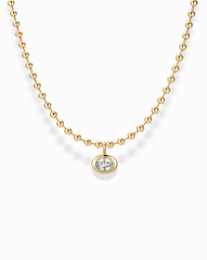 The Soren Bezel Pendant Necklace by Mod + Jo is a 14k gold plated, nickel-free beaded necklace with a round lab-grown white sapphire pendant, shown on a white background.