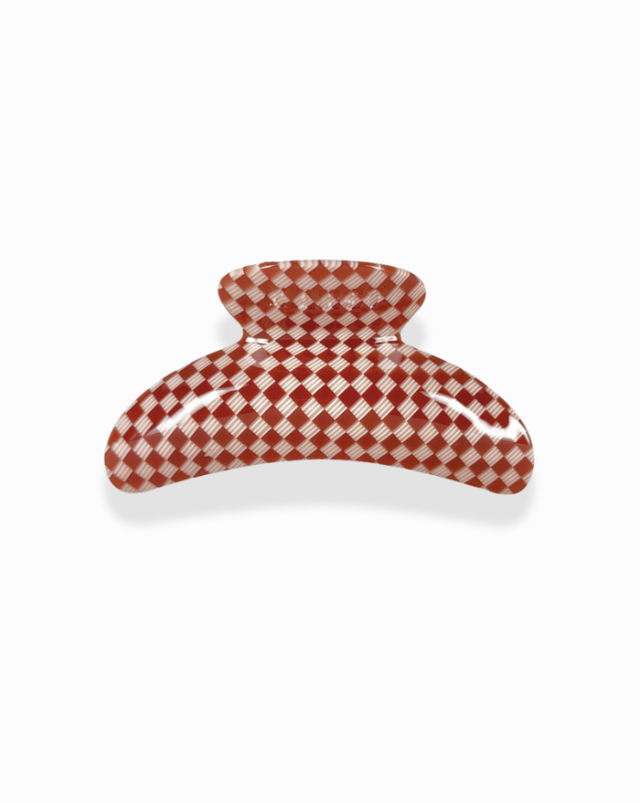 The SuperClip Hair Claw is a large, durable cellulose acetate hair clip with a red and white checkered pattern, shown on a white background.