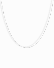 The Winnie Sparkle Chain Necklace, a thin sterling silver piece, is displayed against a plain white background—ideal for elegant layering.