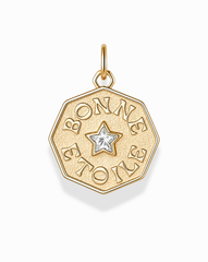 Introducing the Bonne Etoile Charm by Mod + Jo—an elegant gold octagonal pendant featuring a star-shaped gem at its center and "BONNE ETOILE" engraved around the star. This stunning piece of gold coin jewelry is perfect for anyone seeking their own lucky star necklace.