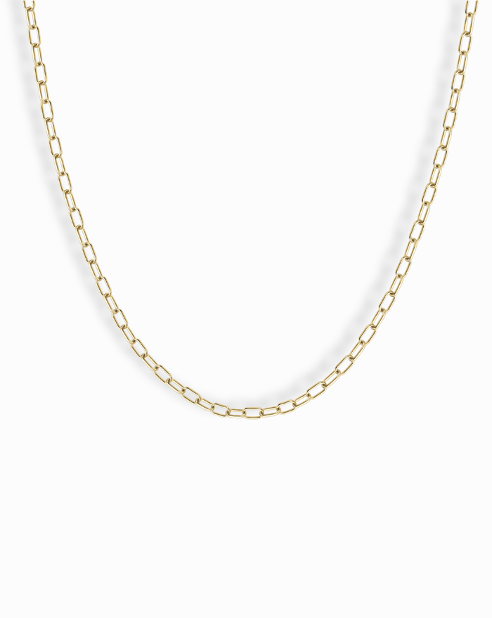 The Mod + Jo Darcy Mini Paperclip Chain Necklace features small, rectangular gold plated links and is displayed against a plain white background.