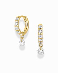 Gold hoop earrings with clear gemstones on a white background