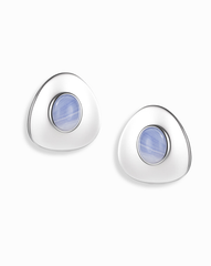 The Mod + Jo Hunter Statement Studs are silver triangular earrings with a central round blue chalcedony stone, shown on a white background.