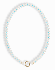 The Macey Gemstone Necklace by Mod + Jo features alternating white jade and light blue round beads, finished with a gold circular clasp at the bottom center.