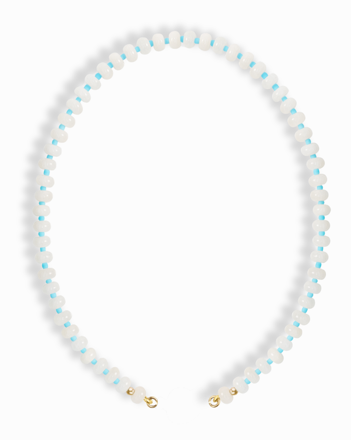 The Macey Gemstone Necklace by Mod + Jo features alternating small white jade and light blue beads in a circular pattern, finished with gold-colored clasps.