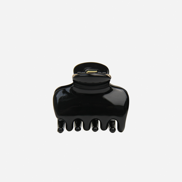 The BRAID & BOW Medium Black Swirl Hair Claw, made from black plastic with five prongs, is featured against a plain white background. This chic hair accessory provides a strong, secure hold for everyday styling.