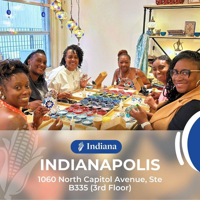 Group of women crafting colorful mosaic glass art at art studio in Indianapolis, Indiana