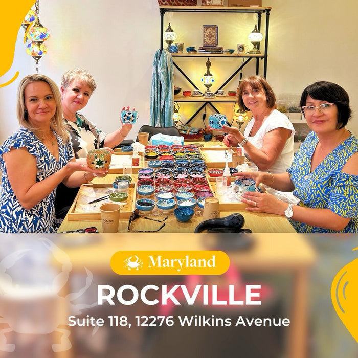 Four women holding handmade mosaic candle holders at a craft workshop in Rockville, Maryland