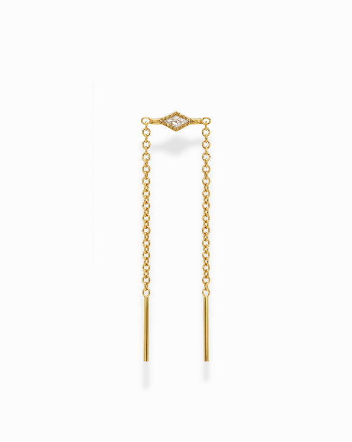 The Nicole Kite Threader Earring by Mod + Jo features a gold-plated threader design with a marquise-shaped cubic zirconia at the top center and two delicate chains ending in straight gold bars, displayed on a white background.