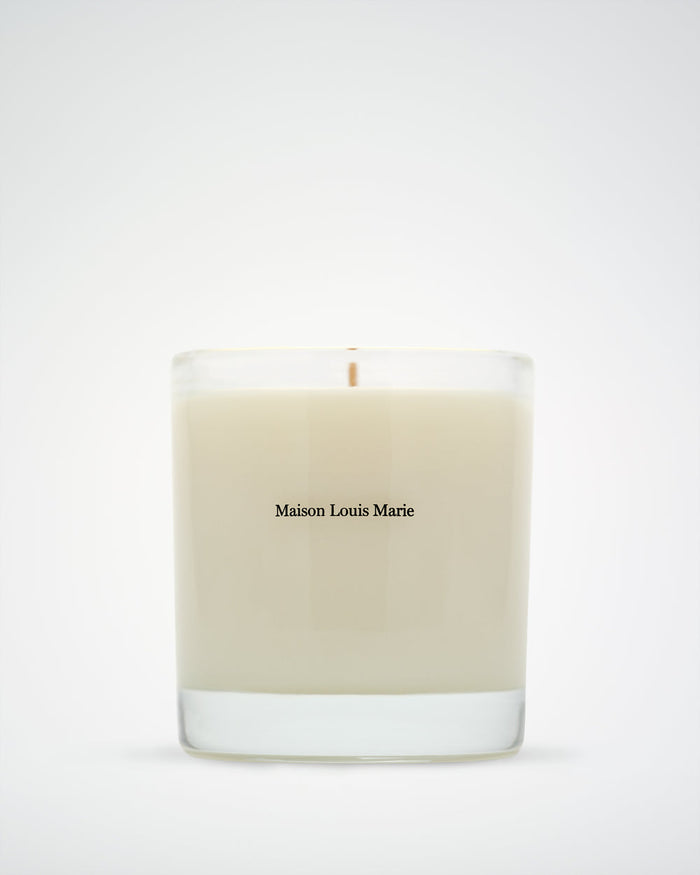 Beige candle with 'Maison Louis Marie' branding on a white background