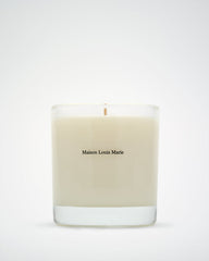 Beige candle with 'Maison Louis Marie' branding on a white background