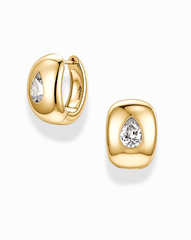 Introducing the Penn Gemstone Hoops by Mod + Jo: these polished, gold-plated brass earrings feature a rounded, cushion-like silhouette. Each hoop showcases a central pear-shaped clear gemstone surrounded by sparkling CZ accents and secures with a hinged closure.