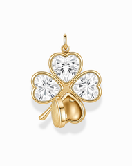 The Perry Four-Leaf Clover Locket Charm by Mod + Jo features a gold clover design, with each leaf crafted from heart-cut CZ crystals and one leaf partially adorned by a delicate gold heart.