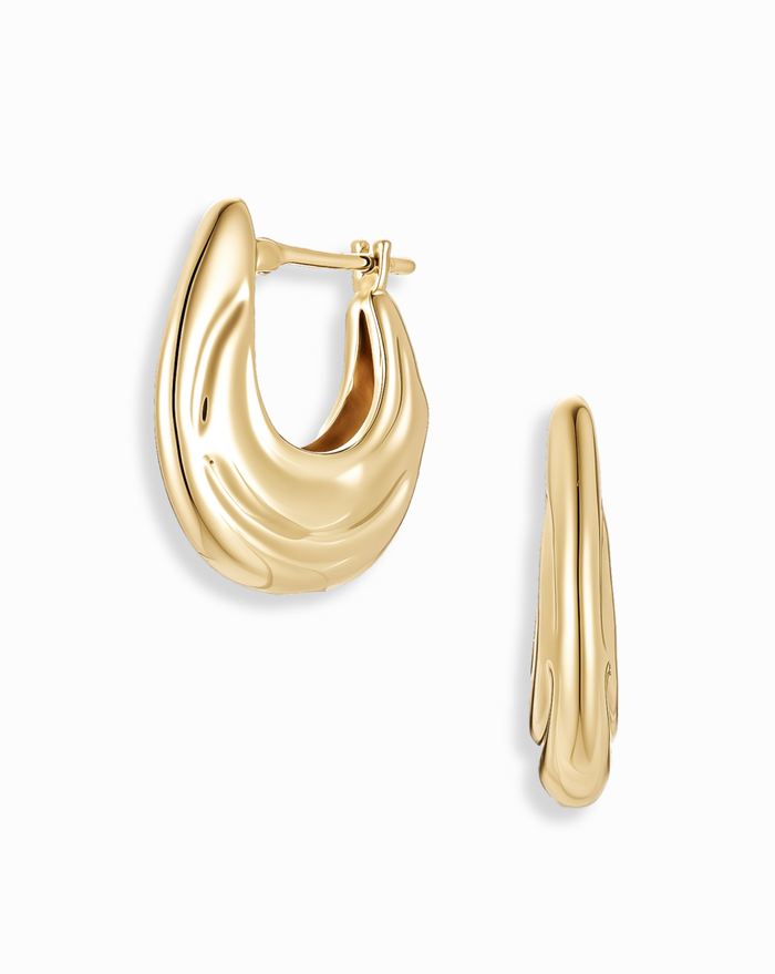 Samara Hoops by Mod + Jo: chunky, shiny 14k gold-plated earrings with a wavy, organic shape, displayed from the front and side on a white background.