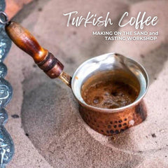 Copper cezve with wooden handle brewing Turkish coffee in hot sand for workshop