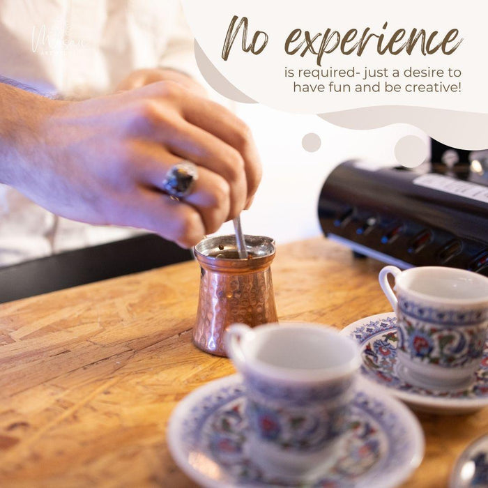 Hand stirring Turkish coffee in copper cezve on wooden table with patterned cups and gas stove